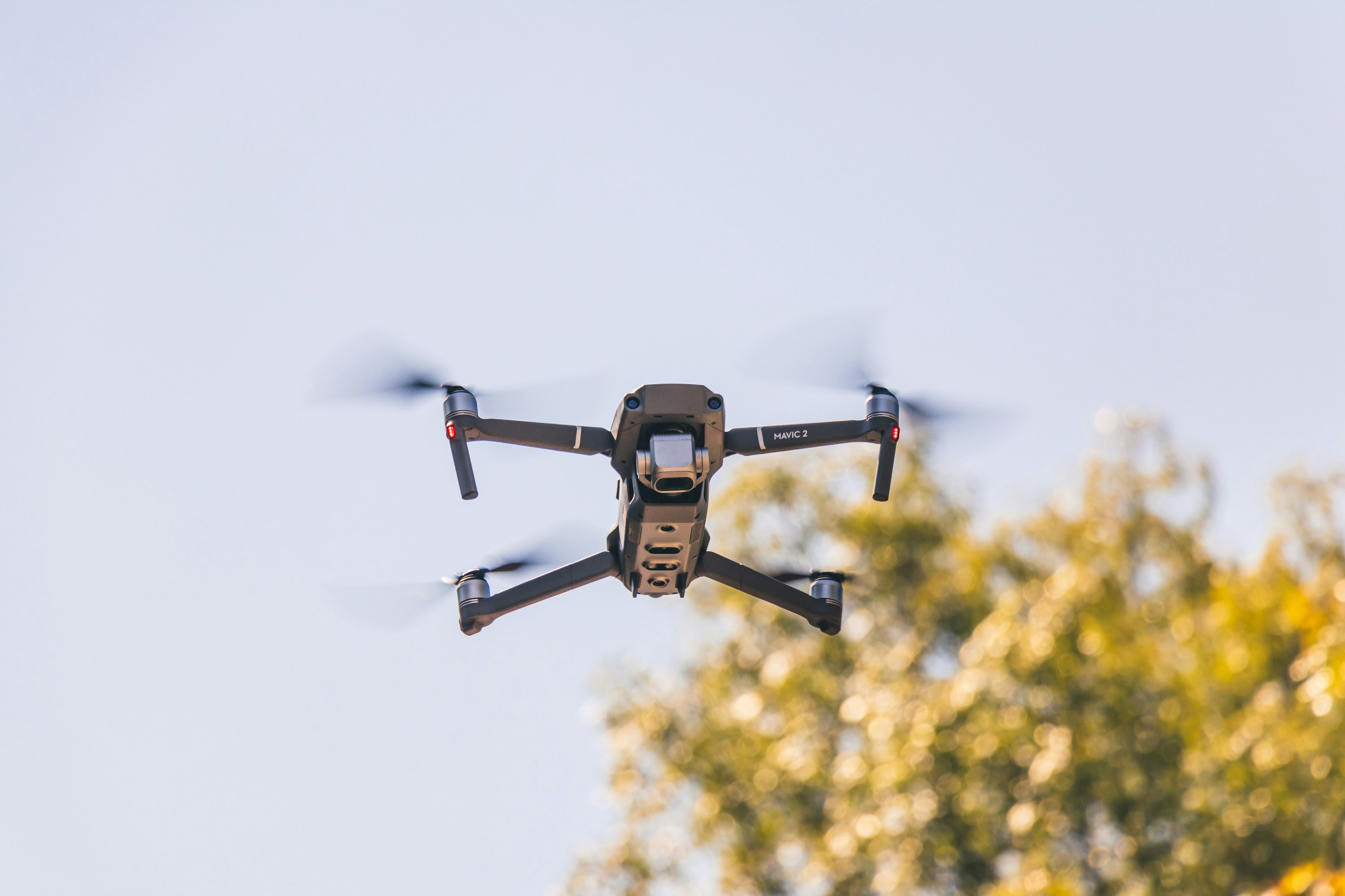 black and white drone flying during daytime